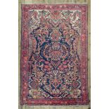 A Hamadan rug, with a large central vase of flowers, on a blue field, 202 x 131cm,