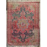 A North West Persian rug, with floral designs, on a red and blue field, 210 x 138cm.