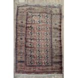A Tekke rug, the rust ground with three rows of nine quartered guls, 188 x 117cm, another similar,