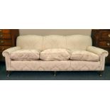 A large reproduction late Victorian style three seat sofa, upholstered in floral figured damask,