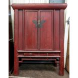 A Chinese red lacquered cupboard, of pan