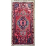 A Hamadan rug, with a central stepped medallion, on a red field, 206 x 102cm, and another,