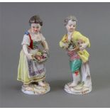 A pair of Meissen figurines of a boy and girl carrying baskets of flowers, early 20th century,