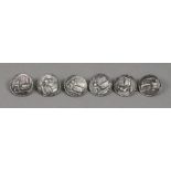 A set of six circular silver buttons, la