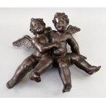 An Italian carved pine hanging figure group of two cherubs, 18th century, in embrace, 37cm high.