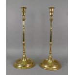 A pair of tall brass candlesticks, in 17