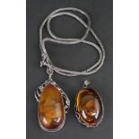 A silver mounted amber pendant necklace, the pear shaped amber,