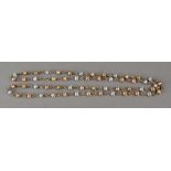 A 9ct tri-gold bead and link long neckla