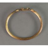 A late Victorian 15ct gold bracelet, of reeded cylindrical hollow form with horseshoe centre,