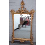 A George III style gilt framed mirror, with acanthus sprays about the rectangular plate,