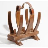 20th century desgin, a teak fish skeleton magazine rack, with leather strap handle,