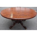 A Victorian figured walnut oval snap top loo table, on four scroll supports, 152cm wide x 72cm high.