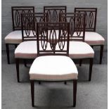A set of six Regency mahogany dining chairs, with triple oval backs on tapering square supports,