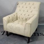 A modern hardwood framed armchair, with button back upholstery, 78cm wide x 87cm high.