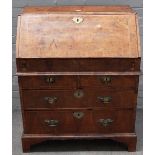 An early 18th century walnut cross and feather banded bureau, with a moulded caddy top,