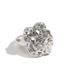 A diamond ring, in a pierced scrolling, floral and foliate design,