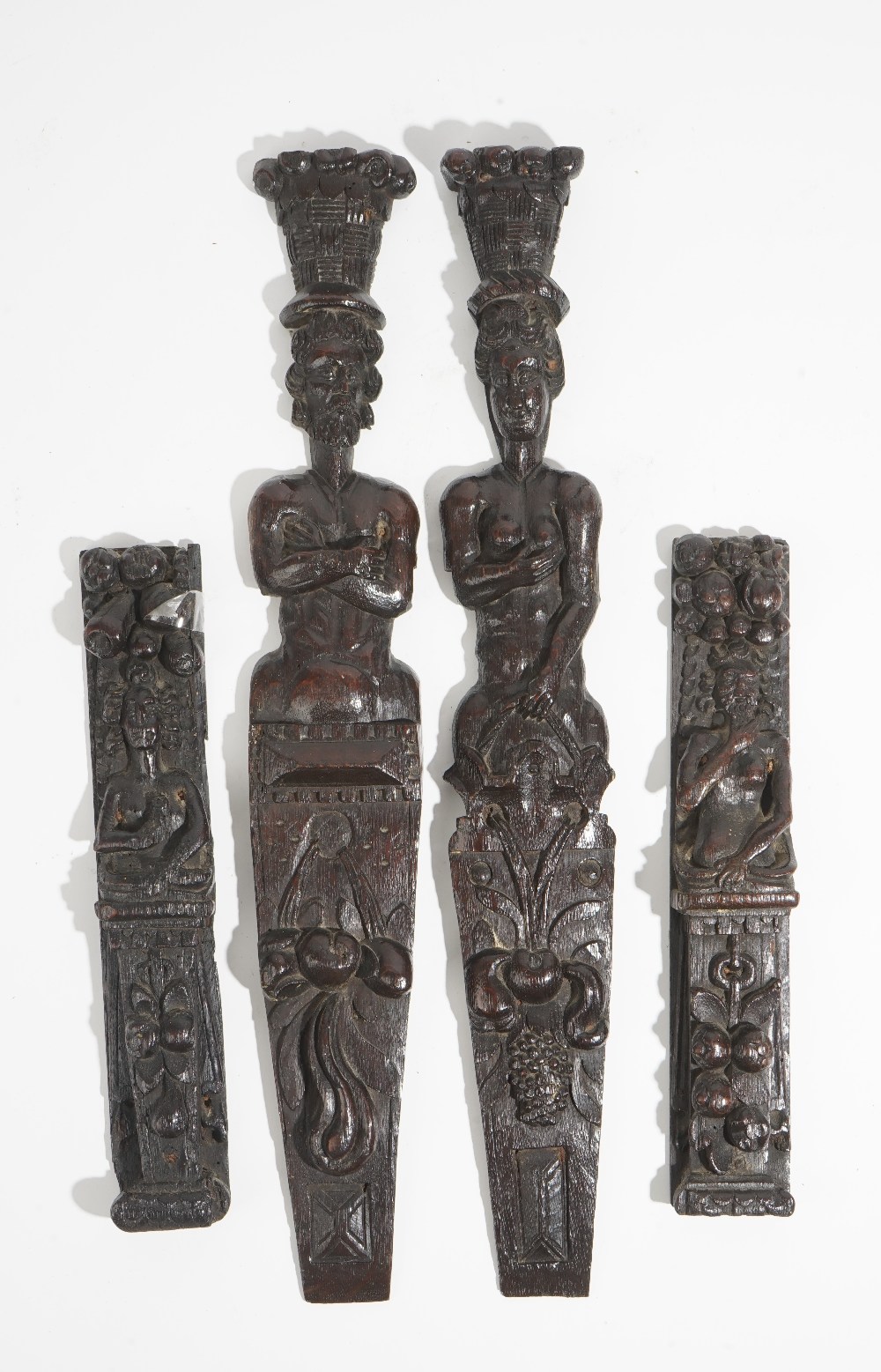 Two pairs of carved oak figural terms, probably Elizabeth I/James I,