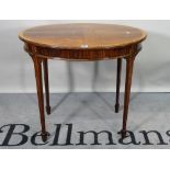 An Edwardian mahogany oval centre table, on tapering square supports, 77cm wide x 69cm high.
