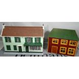 Two modern dolls houses, the larger one modelled as a shop, 94cm wide x 68cm high.