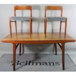 A mid-20th century teak extending dining table, with two extra leaves,