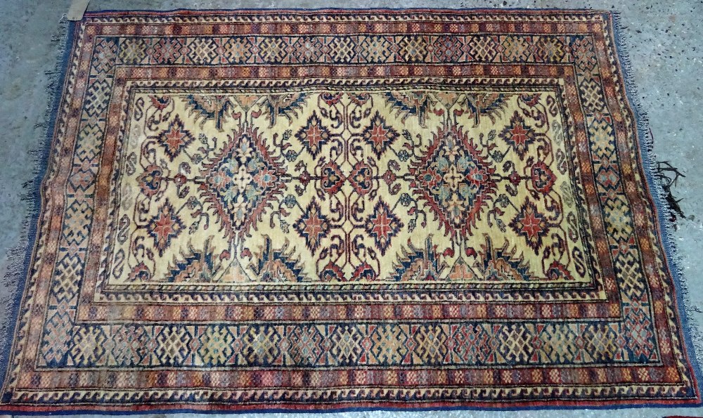 A Shirvan rug, caucasian, the ivory field with two diamonds, other motifs,