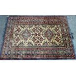 A Shirvan rug, caucasian, the ivory field with two diamonds, other motifs,