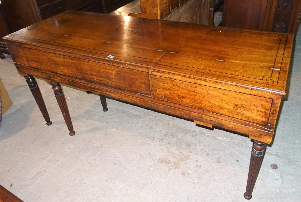 An early Victorian mahogany and ebony inlaid upright piano case, on reeded tapering supports,