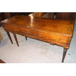 An early Victorian mahogany and ebony inlaid upright piano case, on reeded tapering supports,