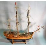 An early 20th century wooden model of a triple mast galleon, 79cm wide x 71cm high.