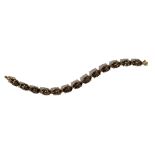 A 9ct gold and smoky quartz bracelet, claw set with a row of thirteen oval cut smoky quartz,