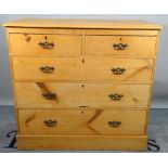A modern pine chest, of two short and three long graduated drawers on plinth base,