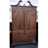 A George III inlaid mahogany linen press, the swan neck cornice over a pair of panel doors,
