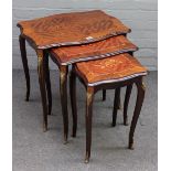 A nest of three gilt metal mounted parquetry inlaid mahogany occasional tables,