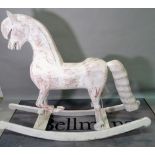 A modern white painted rocking horse of large proportions, 190cm wide x 149cm high.