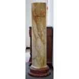 A pair of large marble pedestal columns, yellow veined on rouge marble circular bases,