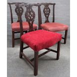 A set of three George III Chippendale style carved mahogany dining chairs,