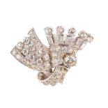 A diamond brooch, in a stylized coronet and spray Art Deco design,