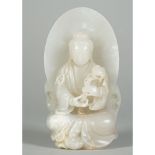 A Chinese white jade figure of Guanyin, 20th century, the goddess seated before an oval mandorla,