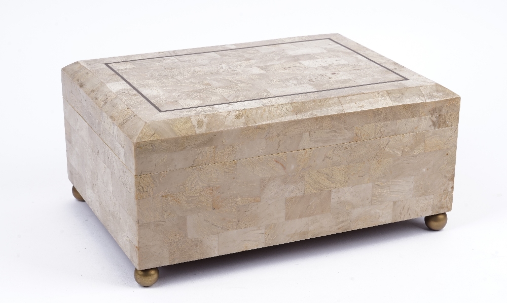 A tessellated marble cigar box by Maitland Smith, raised on spherical brass bun feet, 36cm wide.