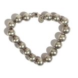 A Tiffany & Co silver bracelet, formed as a row of spherical beads, on a sprung hook shaped clasp,