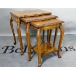 A Victorian style burr walnut nest of three tables, the largest 59cm wide,
