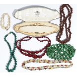 A single row necklace of graduated cultured pearls, on a paste set clasp, with an associated case,