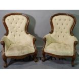 A pair of Victorian style stained beech low armchairs, with button back upholstery,