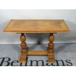 An 18th century style oak centre table, on turned supports united by an H-frame stretcher,