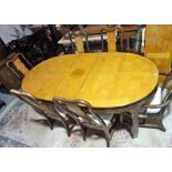 A modern Chinese simulated elm oval extending dining table, two extra leaves,