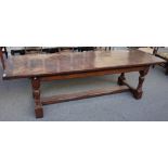 A 17th century style oak refectory table, the cleated plank top on baluster turned supports,