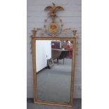 A 19th century French gilt mirror, with eagle and face mask crest over rectangular plate,