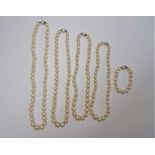 Four single row necklaces of graduated cultured pearls and one single row bracelet,