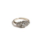 A gold and diamond ring, mounted with the principal circular cut diamond at the centre,