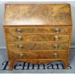 A George III mahogany bureau, the fitted interior over four compartmented drawers,